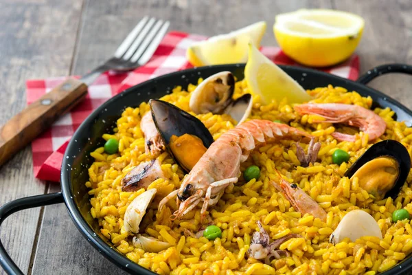 Traditional spanish seafood paella on wooden background — Stock Photo, Image