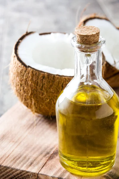 Coconut oil on wooden background — Stock Photo, Image