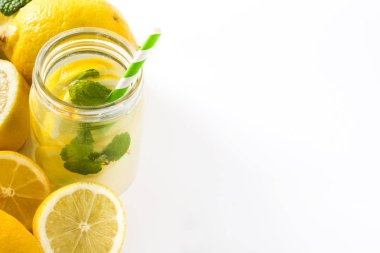 Beyaz arka plan üzerinde izole bir kavanoz cam limonata içmek