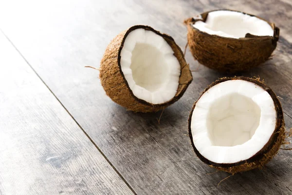 Half coconuts fruit on wooden background — Stock Photo, Image