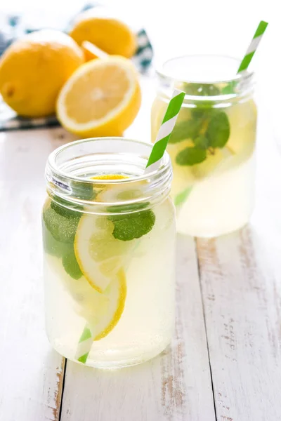 Lemonade drink in a jar glass on white wooden background. Copyspace. — Stock Photo, Image