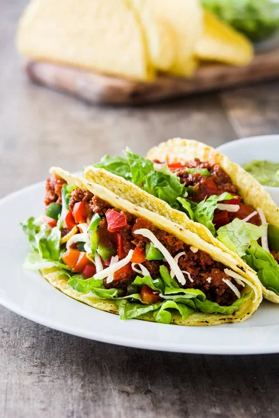 Traditionele Mexicaanse taco's met vlees en groenten op houten achtergrond — Stockfoto