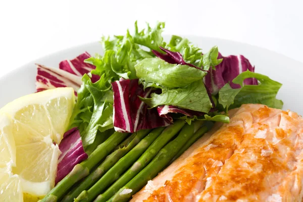 Filete de salmón a la parrilla con espárragos y ensalada en plato aislado sobre fondo blanco — Foto de Stock