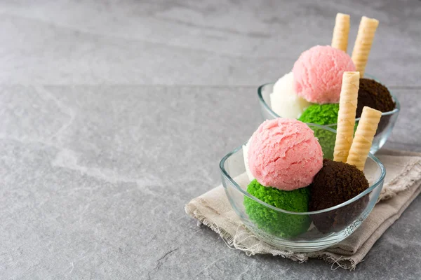 Ice cream scoops in crystal bowl on gray stone — Stock Photo, Image