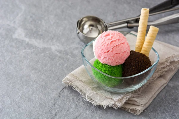 Ice cream scoops in crystal bowl on gray stone — Stock Photo, Image