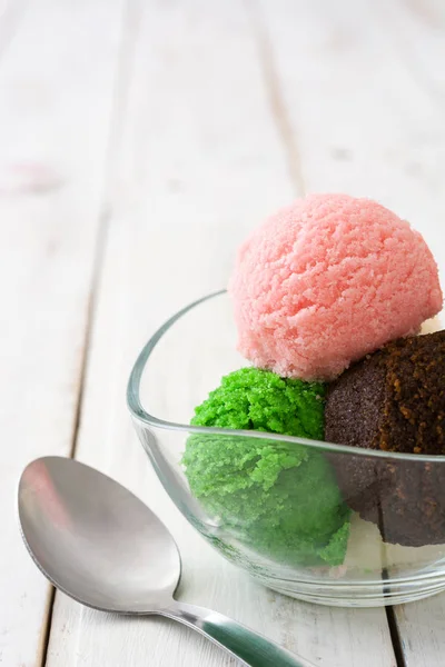 Ice cream scoops in crystal bowl on white wood — Stock Photo, Image