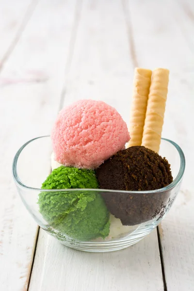 Ice cream scoops in crystal bowl on white wood — Stock Photo, Image