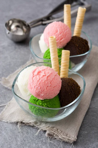 Ice cream scoops in crystal bowl on gray stone — Stock Photo, Image