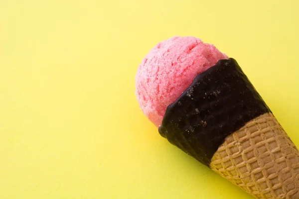 Strawberry Ice cream cones on yellow background — Stock Photo, Image