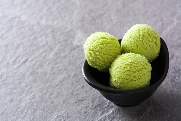 Green tea matcha ice cream scoops on gray stone background — Stock Photo, Image