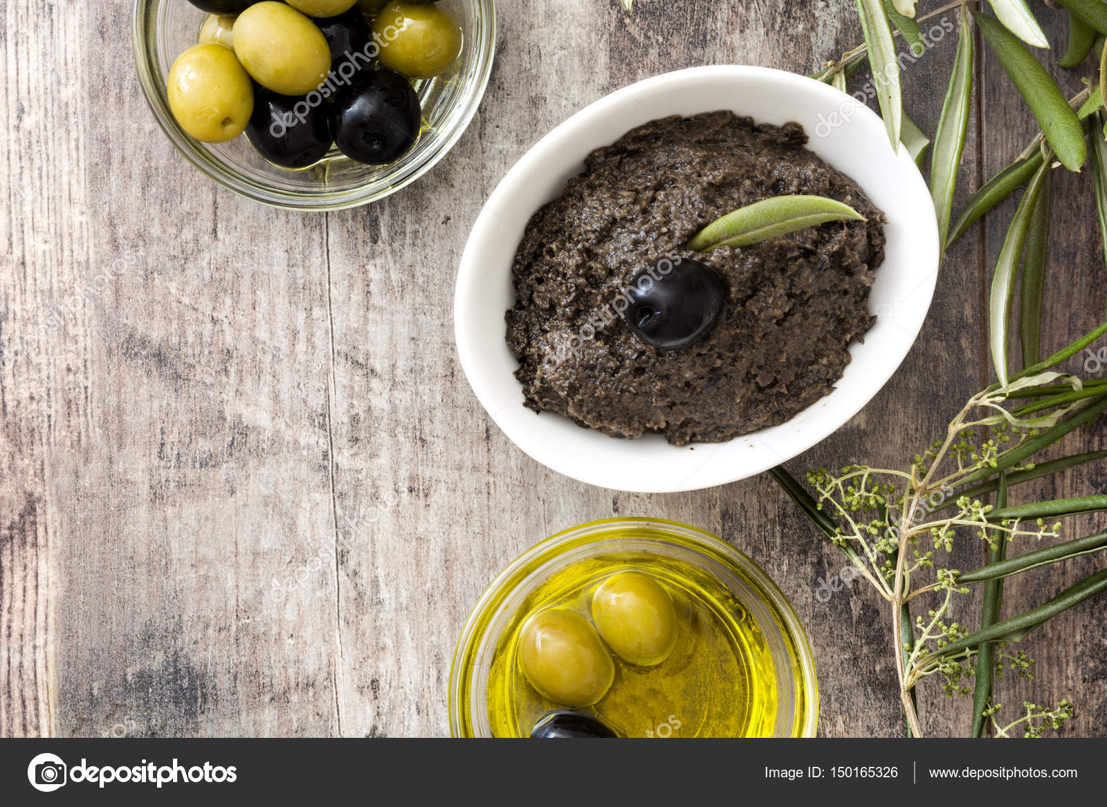 Black olive tapenade with anchovies, garlic and olive oil on wooden ...