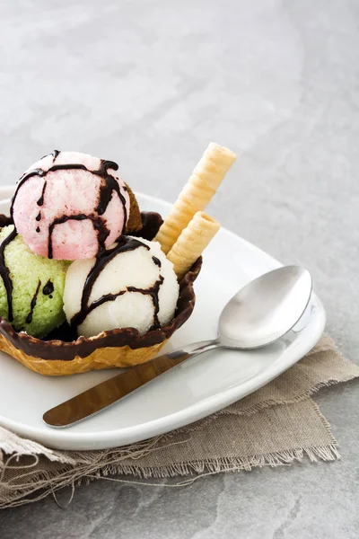 Ice cream scoops served in waffle basket on gray stone — Stock Photo, Image