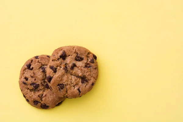 Chocolate chip cookies on yellow background