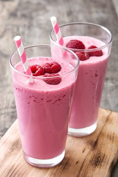 Raspberry smoothie in glass on wooden table — Stock Photo, Image