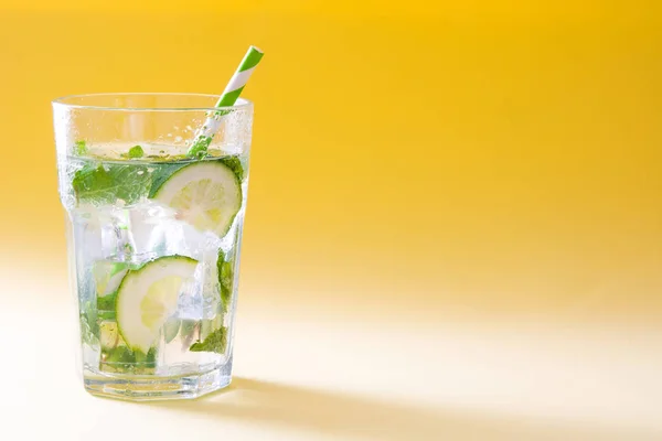 Mojito cocktail in glass on yellow background — Stock Photo, Image