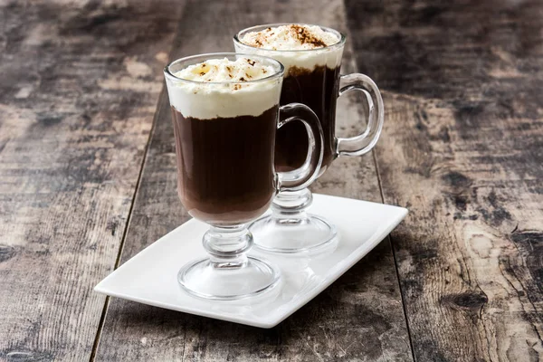 Irish coffee in glass on wooden background — Stock Photo, Image