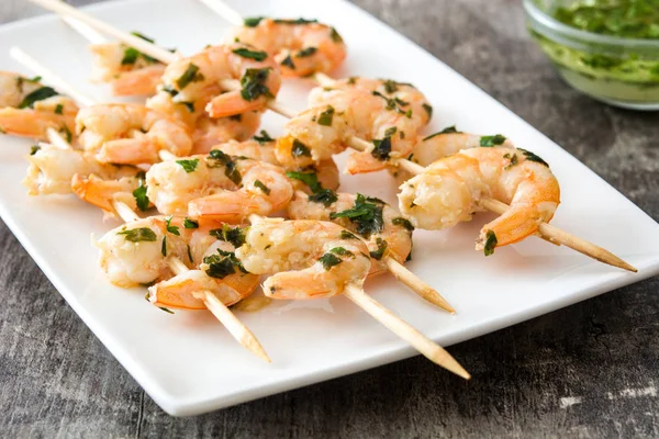 Shrimp skewers on wooden table — Stock Photo, Image