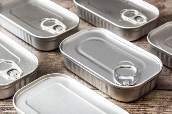 Latas cerradas de conservas sobre mesa de madera — Foto de Stock