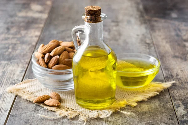 Almond oil in bottle on wooden table