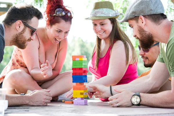 Friends playing block game — Stock Photo, Image