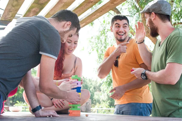 Friends playing block game — Stock Photo, Image