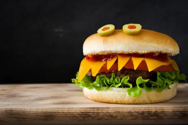 Halloween burger monsters on wooden table.Copyspace — Stock Photo, Image