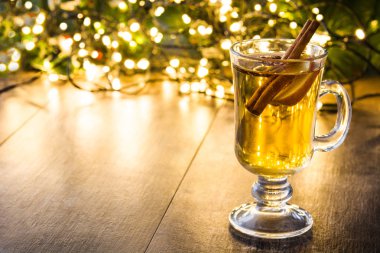 cam, süs eşyaları ve Noel ışık ahşap masa üzerinde mulled elma şarabı. Boşaltmak