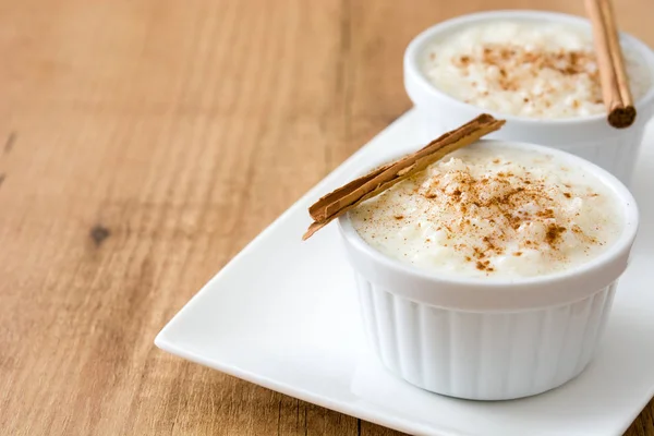 Arroz con leche. Rice pudding with cinnamon on wooden background — Stock Photo, Image