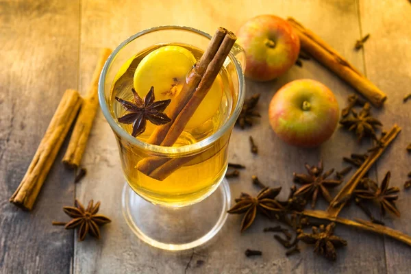 Mulled cider in glass on wooden table. Christmas drink — Stock Photo, Image