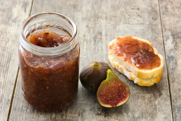 Sweet fig jam in jar on wooden table — Stock Photo, Image