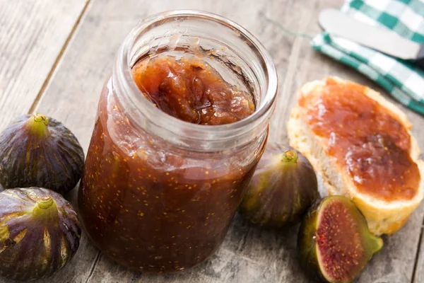 Sweet fig jam in jar on wooden table — Stock Photo, Image