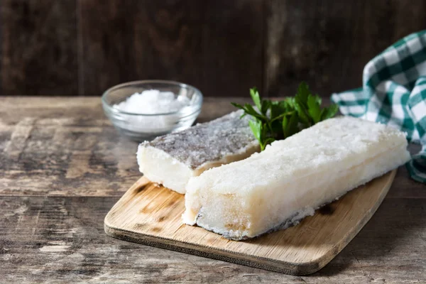 Salted dried cod on wooden table. Typical Easter food