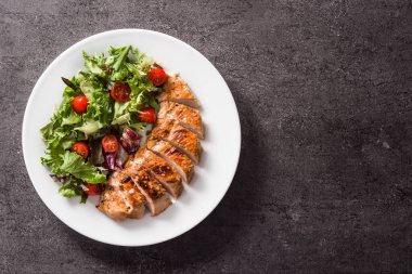 Siyah arka planda sebzeli ızgara tavuk göğsü. Üst Manzara. Boşluğu kopyala