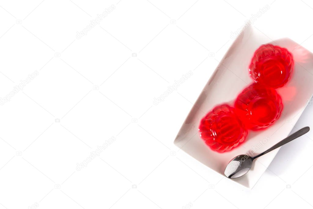 Strawberry jellies on a plate isolated on white background. Top view. Copy space