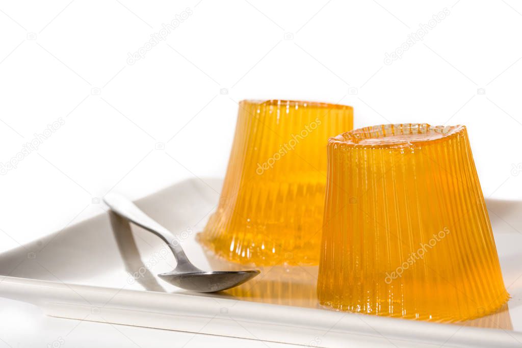 Orange jellies on a plate isolated on white background