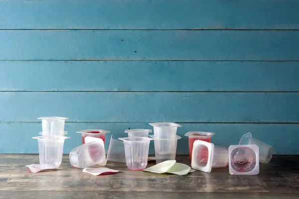 Empty Plastic Cups Jellies Wooden Background Copy Space — Stock Photo, Image