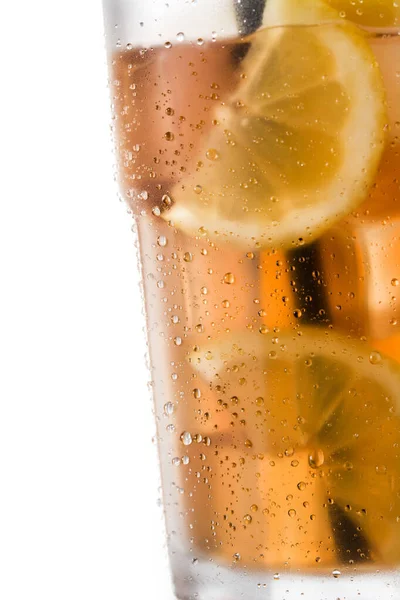 Iced tea drink with lemon in glass isolated on white background. Close up