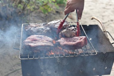 Chuck roll steak. grilled chuck roll Cooking meat by a professional cook on a bonfire in the fresh air.