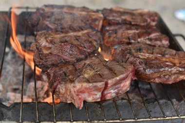 Chuck roll steak. grilled chuck roll Cooking meat by a professional cook on a bonfire in the fresh air.