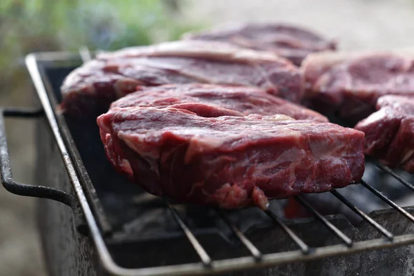 Chuck rotola bistecca. rotolo di mandrino alla griglia Cucinare la carne da un cuoco professionista in un falò all'aria aperta . — Foto Stock