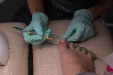Jel tırnak cilası uygulayarak ana pedikür aletleri. Spa. Kavram vücut bakımı.