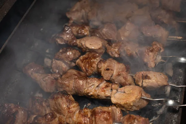 Close-up of grilling tasty dish on barbecue. Process of cooking yummy shashlik in nature. Delicious food — Stock Photo, Image