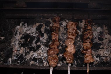 Barbeküde ızgara lezzetli yemeklere yakın çekim. Doğada lezzetli şiş kebap pişirme süreci. Lezzetli yemek.