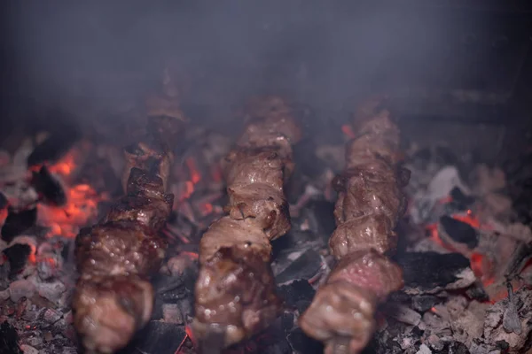 Close-up of grilling tasty dish on barbecue. Process of cooking yummy shashlik in nature. Delicious food — 스톡 사진