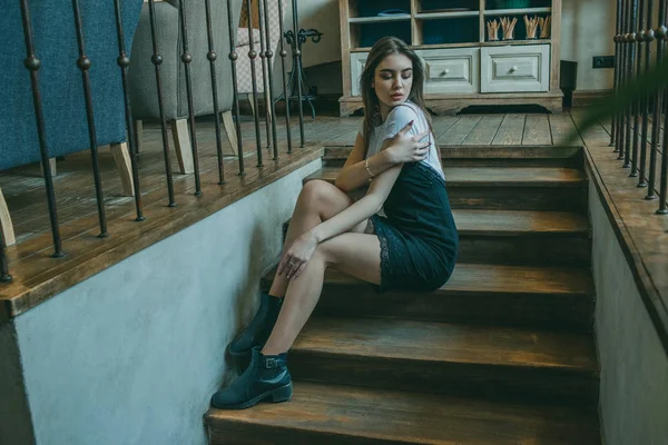 Mooi elegant brunette meisje draagt een zwarte jurk is ontspannen in een straat cafe. Reclame, mode. Getinte foto — Stockfoto