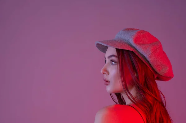 A young girl looks into the distance. Close-up. Profile