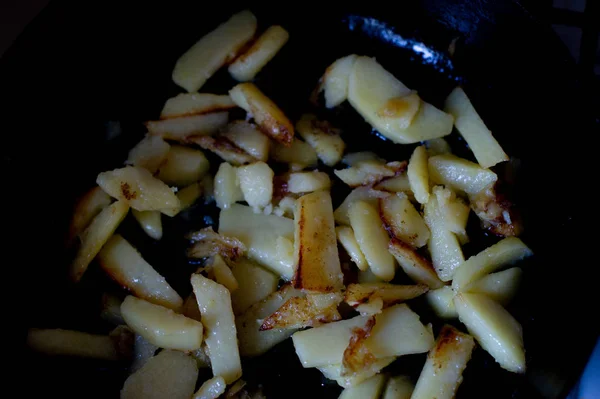 Vegetables cut in cubes fried on frying pan, in kitchen.Potatoes fried in cubes in a pan — Stock Photo, Image