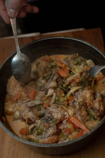 Braised chicken curry with vegetables. Asparagus, carrots, onions. Stewed chicken. Food photography