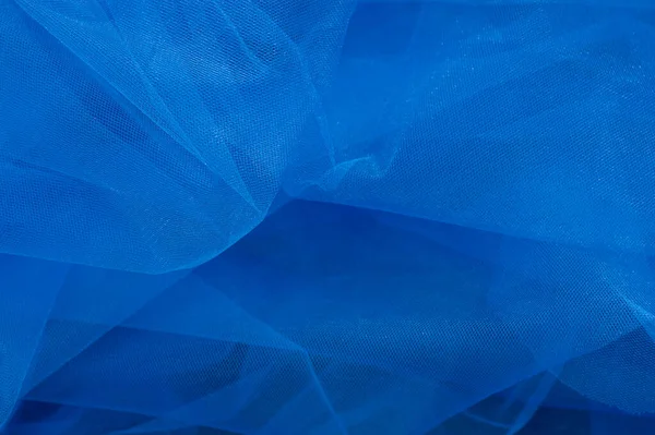Blue fabric mesh.  color of light fabric in daylight. Textile, blue.  color of light fabric in daylight. Textile, blue