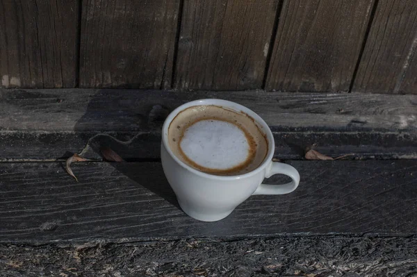 Coffee selective focus. White cup with cappuccino on the nature. White cup with cappuccino, coffee, morning, cheerfulness.